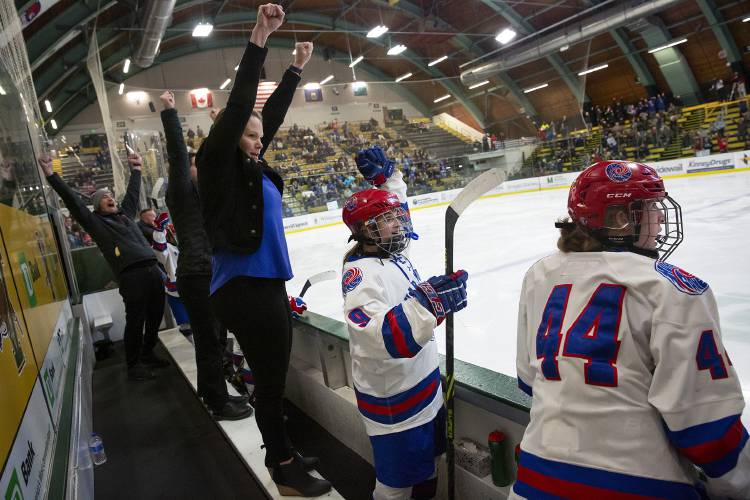 From left, Hartford assistant coaches Jason Gramling and Karli Swensen, head coach Kylie Young, and players Aubree Vail (9) and Flynn Moreno (44) cheer after a goal by Zoe Zanleoni propels the team into the lead during the VPA D-II girls hockey championship game against Missisquoi at Gutterson Fieldhouse in Burlington, Vt., on Tuesday, March 5, 2024. Hartford won, 5-3. (Valley News / Report For America - Alex Driehaus) Copyright Valley News. May not be reprinted or used online without permission. Send requests to permission@vnews.com.