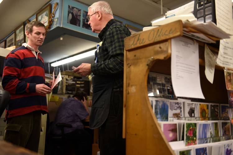 Dan Fraser, left, and his father George Fraser in the office at Dan & Whit's in Norwich, Vt., on Feb. 9, 2015. (Valley News - Jennifer Hauck) Copyright Valley News. May not be reprinted or used online without permission. Send requests to permission@vnews.com. 