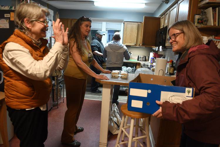 Volunteers MaryAnn Haagen, of Lebanon, N.H., left, and Becky Torrey, of Etna, N.H., gather their things after bringing dinner to the Hartford Dismas House on Wednesday, April 10, 2024, in Hartford Village, Vt. In the middle is Wendy John, the transition coordinator at the house. The women were there as part of a group from the Church of Christ at Dartmouth College. The home celebrated their 10th anniversary last month. (Valley News - Jennifer Hauck) Copyright Valley News. May not be reprinted or used online without permission. Send requests to permission@vnews.com.