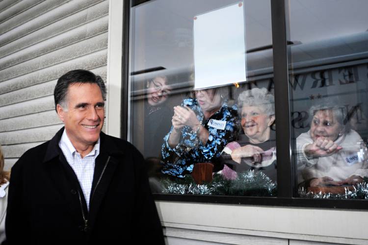 From right, Flora Kangas, Janice Newton and Patti Goulette, all of Newport, N.H., catch a glimpse of presidential primary candidate Mitt Romney as he stops at Village Pizza in Newport Wednesday, December 21, 2011. (Valley News - James M. Patterson) Copyright Valley News. May not be reprinted or used online without permission. Send requests to permission@vnews.com.
