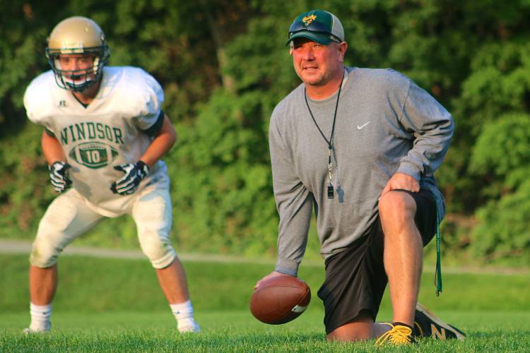 Jamie Richardson, right, prepares to start a drill during Windsor High's Aug. 26, 2017 football practice. Richardson is the Yellowjackets' defensive coordinator and the head baseball coach. (Tris Wykes - Valley News) Copyright Valley News. May not be reprinted or used online without permission. Send requests to permission@vnews.com.
