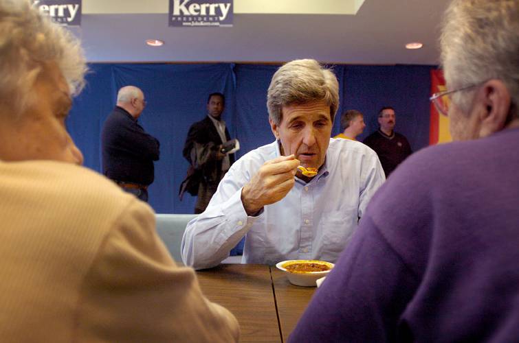 Presidential candidate Senator John Kerry eats chili with Claremont, N.H., residents Gilberte Desilets, left, and Jean Bergeron at the Earl Bourdon senior center in Claremont on December 10, 2003. Kerry spoke and served chili to residents. (Valley News - Edmund Fountain) Copyright Valley News. May not be reprinted or used online without permission. Send requests to permission@vnews.com.