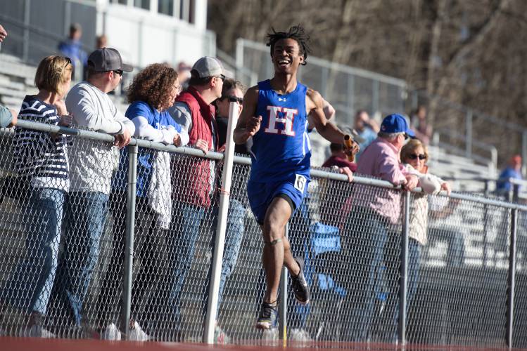 Ayodele Lowe crosses the finish line, capping off a 45.42 second win for
 his teammates Hayden Hewitt, Payton Bessette, and Gabe Guillette in the
 4x100 meter relay in Windsor, Vt., on Tuesday, April 16, 2024. (Valley News - James M. Patterson) Copyright Valley News. May not be reprinted or used online without permission. Send requests to permission@vnews.com.