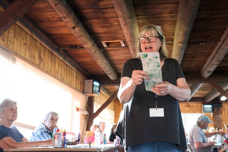Vicki Pellerin, of Enfield, checks over a card after bingo was called during the weekly game she runs at the LaSalette Shrine in Enfield, N.H., on Tuesday, August 1, 2023. Pellerin has proposed opening a Bingo hall at the Shaker Valley Auto showroom in Enfield. (Valley News - James M. Patterson) Copyright Valley News. May not be reprinted or used online without permission. Send requests to permission@vnews.com.