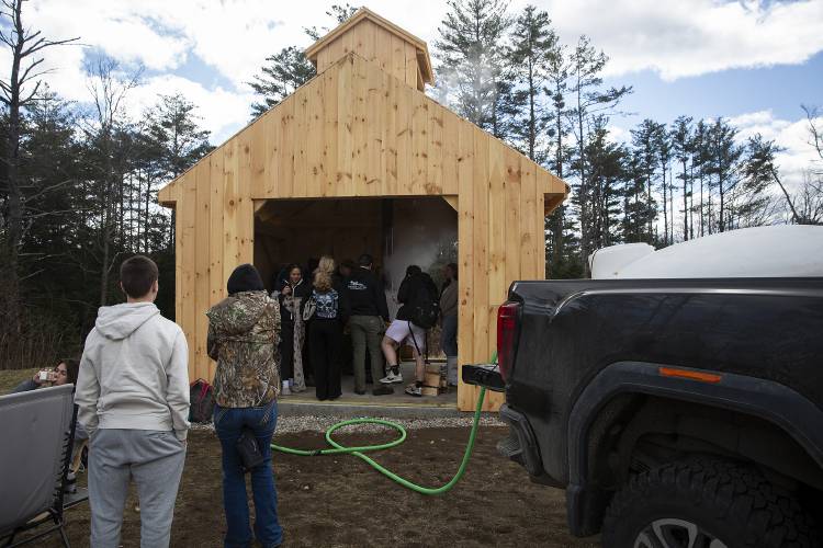 Students stop by to get a look at the sugaring operation in a new student-built sugar shack at Mascoma Valley Regional High School in West Canaan, N.H., on Monday, March 18, 2024. “It’s pretty cool that we’re carrying on a New England tradition,” school resource officer Matt Bunten said, noting that when students started boiling sap in a science class last year, several of them had no idea where syrup came from. (Valley News / Report For America - Alex Driehaus) Copyright Valley News. May not be reprinted or used online without permission. Send requests to permission@vnews.com.