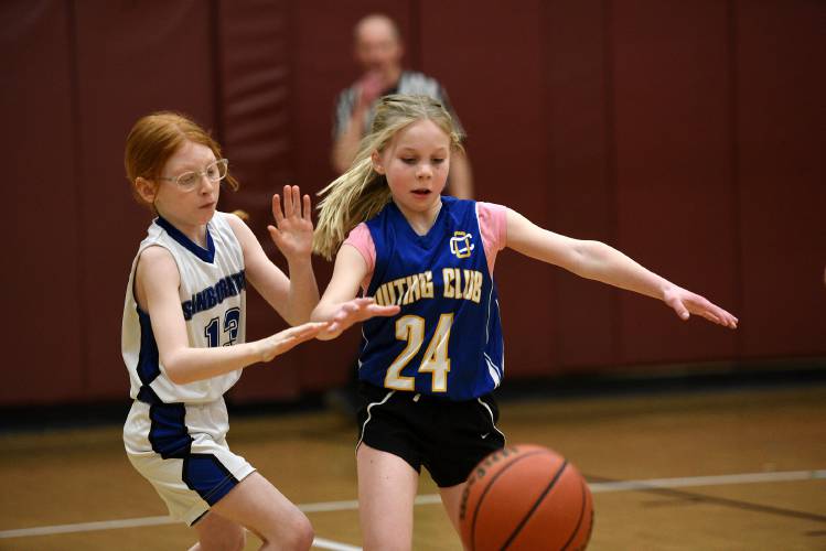 Sanborton's Emma Patsfield, left, and New London Outing Club's Skylin Parthum chase after a loose ball during the girls third- and fourth-grade basketball game during the Karp’s Klassic on Thursday, March 14, 2024, in Lebanon, N.H. (Valley News - Jennifer Hauck) Copyright Valley News. May not be reprinted or used online without permission. Send requests to permission@vnews.com.