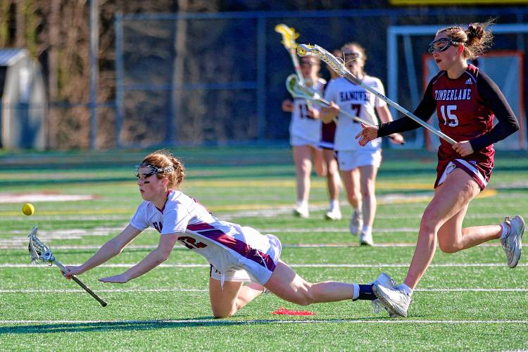Hanover High's Nora Bradley falls to the turf in front of Timberlane's Maia Parker during the NHIAA Division II teams' game on April 25, 2024, on Merriman-Branch Field in Hanover, N.H. 