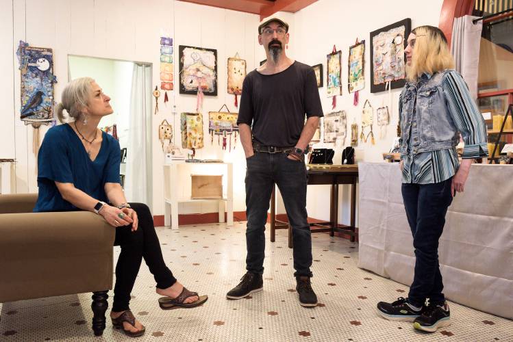 Angie Follensbee-Hall, left, her husband, Joshua Hall, middle, and their daughter Isabella Hall, right, have started a new gallery, Jai Studios Gallery and Gifts in the Windsor House in Windsor, Vt., where they spoke with Alex Hanson, of the Valley News on Tuesday, August 29, 2023. Follensbee-Hall makes art with her own hand-made paper, Joshua Hall is a music teacher at Richmond Middle School and a candle maker, and Isabella Hall is cartoonist. (Valley News - James M. Patterson) Copyright Valley News. May not be reprinted or used online without permission. Send requests to permission@vnews.com.