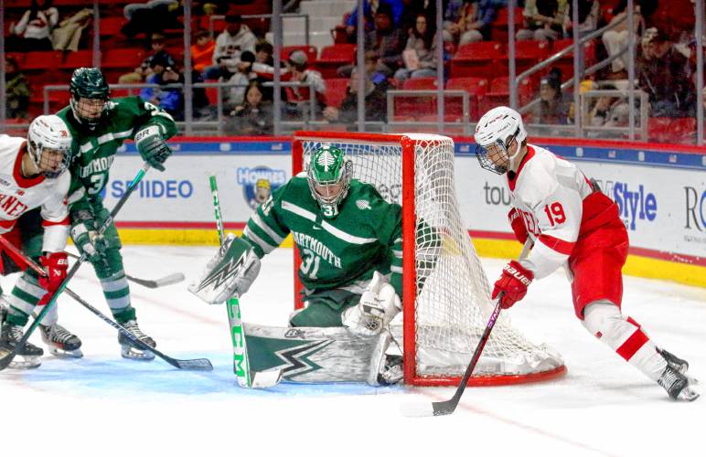 Dartmouth College goaltender Cooper Black watches Cornell's Sullivan Mack, right, approach his net with the puck during the ECAC teams' playoff semifinal at Herb Brooks Arena in Lake Placid, N.Y. Mack, a former Kimball Union Academy player, and his Big Red won, 6-3. (Valley News - Tris Wykes) Copyright Valley News. May not be reprinted or used online without permission. 