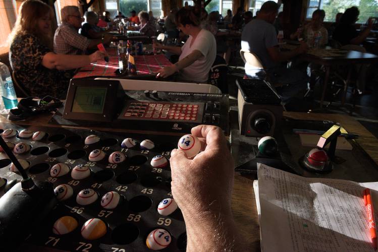 Bingo caller Roy Holland calls the numbers for a bingo game at the LaSalette Shrine in Enfield, N.H., on Tuesday, August 1, 2023. The weekly game filled two floors of the building with 86 players. (Valley News - James M. Patterson) Copyright Valley News. May not be reprinted or used online without permission. Send requests to permission@vnews.com.