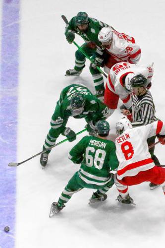Dartmouth College's Trym Lokkeberg (22) wins a faceoff against Cornell's Tyler Catalano during the ECAC teams' playoff semifinal on March 23, 2024, at Herb Brooks Arena in Lake Placid, N.Y. Cornell won, 6-3. Dartmouth's Nate Morgan (68) and Luke Devlin jockey for position. (Valley News - Tris Wykes) Copyright Valley News. May not be reprinted or used online without permission. 