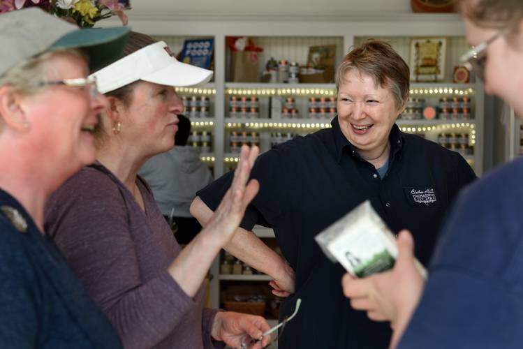 Blake Hill Preserves owner Vicky Allard chats with customers Elaine DeLong, left, Kristina Gould, and Sidney Gould, all of Enfield, Conn., at the store in Windsor, Vt., on Tuesday, April 10, 2024. As part of a larger financing package, the business is applying for funding through the Town of Windsor to support a $2.7 million facility expansion in Artisan Park. (Valley News - Jennifer Hauck) Copyright Valley News. May not be reprinted or used online without permission. Send requests to permission@vnews.com.