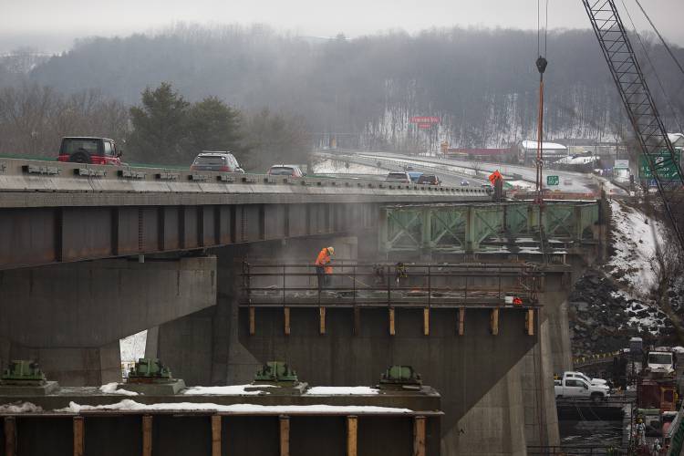 A construction crew from Bow, N.H.-based firm R.S. Audley works to remove the steel superstructure of an Interstate 89 bridge that spans the Connecticut River in West Lebanon, N.H., on Thursday, March 28, 2024. The bridge, which previously held southbound traffic, is being rehabilitated as part of a five-year project that will combine the two original bridges with a median bridge in order to create auxiliary lanes and expand shoulders to improve overall safety. (Valley News / Report For America - Alex Driehaus) Copyright Valley News. May not be reprinted or used online without permission. Send requests to permission@vnews.com.