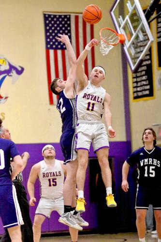 Mascoma High's James Thomas (11) leaps for the opening jump ball against White Mountains' Avery Woodburn during the NHIAA Division III teams' playoff quarterfinal meeting on Feb. 16, 2024, in West Canaan, N.H. Mascoma won, 62-47, in overtime. (Valley News - Tris Wykes) Copyright Valley News. May not be reprinted or used online without permission.