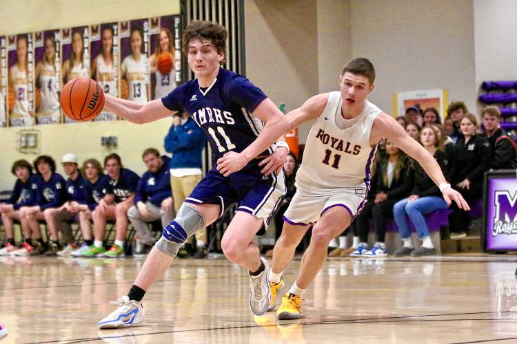 Mascoma High's James Thomas, right, pursues White Mountains' Trevor Armstrong during the NHIAA Division III teams' playoff quarterfinal meeting on Feb. 16, 2024, in West Canaan, N.H. Mascoma won, 62-59, in overtime. (Valley News - Tris Wykes) Copyright Valley News. May not be reprinted or used online without permission.