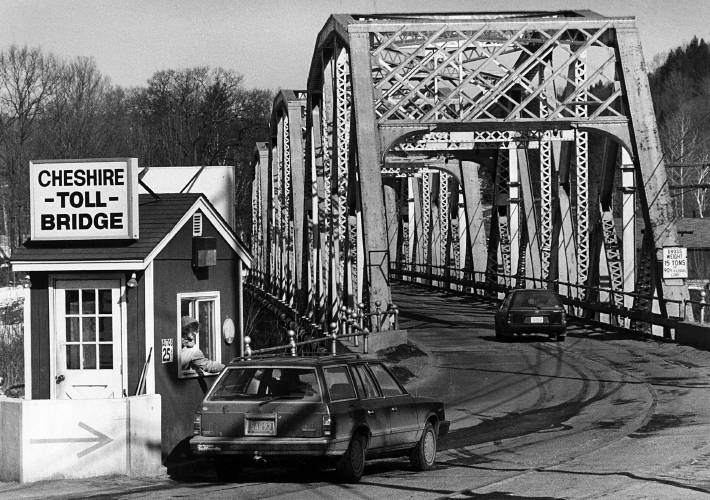A motorist pays the 25-cent toll before crossing the Cheshire Toll Bridge between Charlestown, N.H., and Springfield, Vt., in an undated photograph. The bridge’s toll-taking operation cased in 2001. (Valley News photograph) Copyright Valley News. May not be reprinted or used online without permission. Send requests to permission@vnews.com.