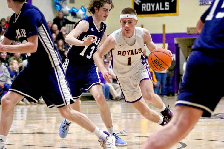 Mascoma High's Tanner Moulton dribbles past White Mountains' Eli Beaulieu during the NHIAA Division III teams' playoff quarterfinal clash on Feb. 16, 2024, in West Canaan, N.H. Mascoma won in overtime, 62-59. (Valley News - Tris Wykes) Copyright Valley News. May not be reprinted or used online without permission.