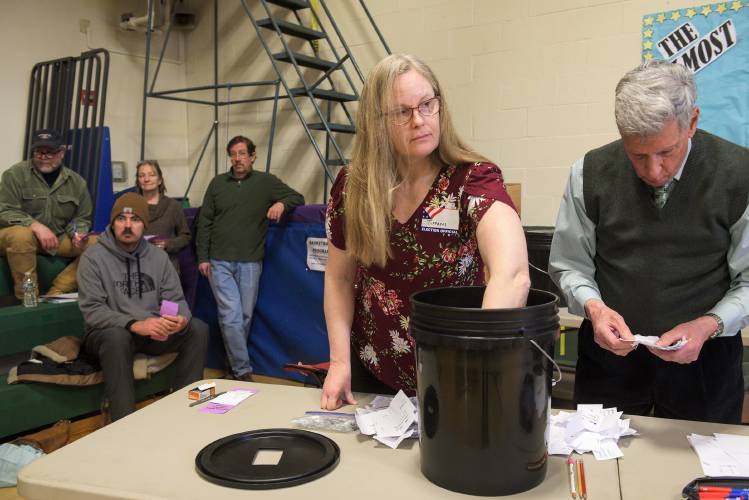 Ballot Clerk Tiffani Price, left, and Assitant Moderator John Carr, right, count ballots from the budget vote at Enfield, N.H., Town Meeing at Enfield Village School on Saturday, March 16, 2024. The $9.4 million budget was approved by voters. (Valley News - James M. Patterson) Copyright Valley News. May not be reprinted or used online without permission. Send requests to permission@vnews.com.