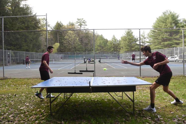 Hanover tennis players Pablo Martin-Asensio, left, and doubles partner Raymond Menkov bat a tennis ball around before the start of Hanover's tennis match with Nashua South in Hanover, N.H., on Monday, May 1, 2023.  (Valley News - Jennifer Hauck) Copyright Valley News. May not be reprinted or used online without permission. Send requests to permission@vnews.com.