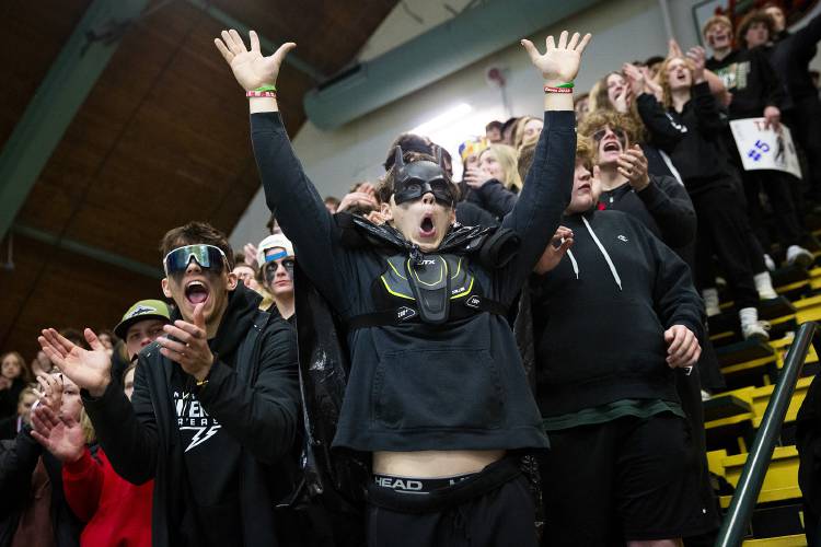 Hartford seniors, from left, Brayden Trombly, Brody Tyburski and Ryan Spaulding cheer from the student section during the VPA D-II boys hockey championship game against Colchester at Gutterson Fieldhouse in Burlington, Vt., on Tuesday, March 5, 2024. Hartford won, 3-1. (Valley News / Report For America - Alex Driehaus) Copyright Valley News. May not be reprinted or used online without permission. Send requests to permission@vnews.com.