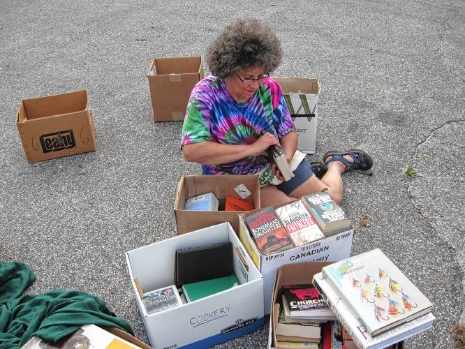 Volunteer Elaine Frank assists with the Richards Free Library's annual Library Festival Book Sale in August 2011. Frank helped organize the sale as a member of the Friends of the Library. (Courtesy Richards Free Library)