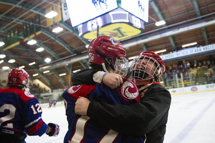 Hartford Tighe Hrabchak, left, and Frankie Cushing celebrate a goal by Ezra Mock with 11 seconds remaining in the VPA D-II boys hockey championship game against Colchester at Gutterson Fieldhouse in Burlington, Vt., on Tuesday, March 5, 2024. (Valley News / Report For America - Alex Driehaus) Copyright Valley News. May not be reprinted or used online without permission. Send requests to permission@vnews.com.