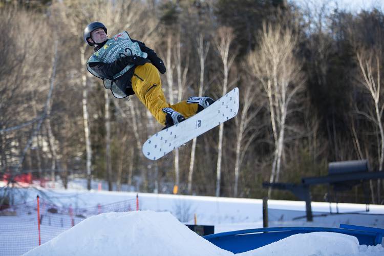 Woodstock’s Zev Wysocki turns as he goes over a ramp during a snowboard meet at Whaleback Mountain in Enfield, N.H., on Tuesday, Feb. 6, 2024. (Valley News / Report For America - Alex Driehaus) Copyright Valley News. May not be reprinted or used online without permission. Send requests to permission@vnews.com.
