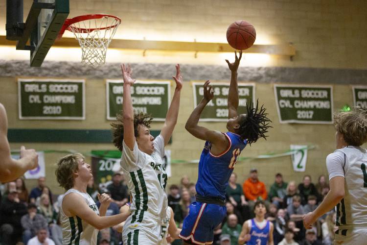 Rivendell’s Gabe Wright-Swaine (13) attempts to block a shot by Hartford’s Ayodele Lowe (12) during a boys varsity basketball game at Rivendell Academy in Orford, N.H., on Tuesday, Feb. 13, 2024. Hartford won, 70-38. (Valley News / Report For America - Alex Driehaus) Copyright Valley News. May not be reprinted or used online without permission. Send requests to permission@vnews.com.