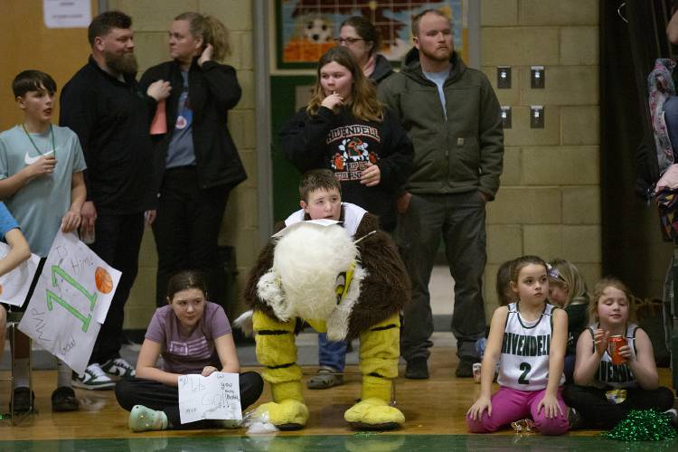 Fifth grader Carter Stygles, 10, of Orford, N.H., takes a break from his mascot duties while watching a boys varsity basketball game at Rivendell Academy in Orford, N.H., on Tuesday, Feb. 13, 2024. (Valley News / Report For America - Alex Driehaus) Copyright Valley News. May not be reprinted or used online without permission. Send requests to permission@vnews.com.
