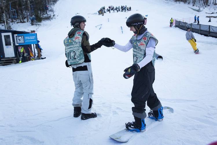 Woodstock’s Jonas Wysocki, left, congratulates Richford’s Mitchell Kane after his run during a snowboard meet at Whaleback Mountain in Enfield, N.H., on Tuesday, Feb. 6, 2024. (Valley News / Report For America - Alex Driehaus) Copyright Valley News. May not be reprinted or used online without permission. Send requests to permission@vnews.com.