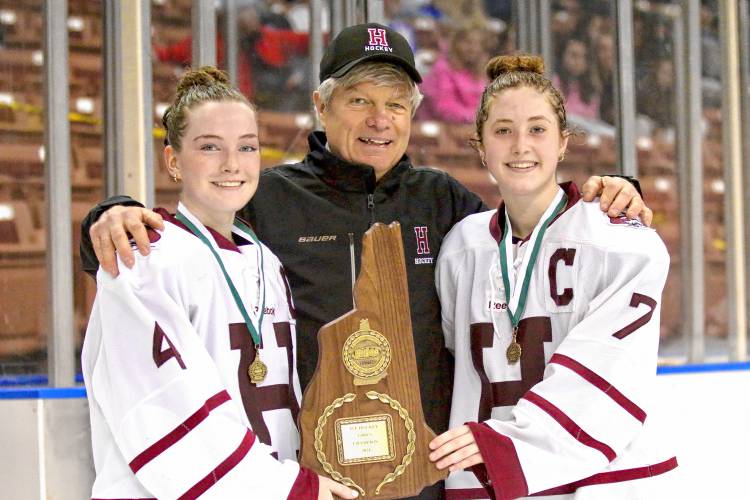 Hanover High girls hockey coach John Dodds is flanked by captains Maeve Lee, left, and Nora Bradley after the Bears beat Oyster River-Portsmouth, 2-1, in the NHIAA Division I title game on March 9, 2024, at SNHU Arena in Manchester, N.H. (Valley News - Tris Wykes) Copyright Valley News. May not be reprinted or used online without permission. 