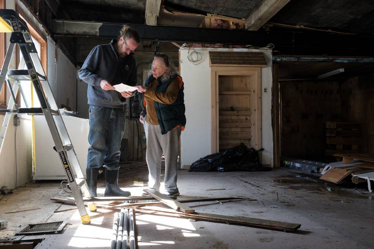Lee Simek, of Sharon, right, stops in to Tracy's Midway Station to talk with Joel Senger, of Sharon, who is renovating the building into commercial space in Sharon, Vt., on Friday, March 8, 2024. Senger, 40, purchased the former service station and convenience store with his wife and a friend last fall and hopes to rent space for a cafe, retail, and other businesses. “We’re open for anything,” said Senger. “It really is an open slate.” (Valley News - James M. Patterson) Copyright Valley News. May not be reprinted or used online without permission. Send requests to permission@vnews.com.