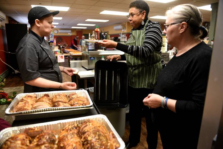 Eben Brock, left, food service director and executive chef at Vermont Law and Graduate School, Shirley Jefferson, Vice President of Community Engagement and Government Relations Associate Professor of Law, and Kat Paiva, catering manager, sample the turkey on Wednesday, Nov. 23, 2022, that will be served for the next day's Thanksgiving community dinner. Jefferson is one of the coordinators for the dinner. They are expected to serve 350 meals, some at the school and some will be delivered to area homes. (Valley News - Jennifer Hauck) Copyright Valley News. May not be reprinted or used online without permission. Send requests to permission@vnews.com.