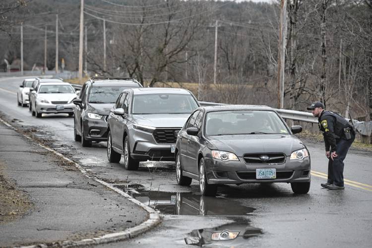  Hanover Cpl. Mike Alterisio turns cars around in front of Lebanon High School, and Hanover Street School, on Friday, March 15, 2024 in Lebanon, N.H. The schools were placed on lockdown after dismissal. 