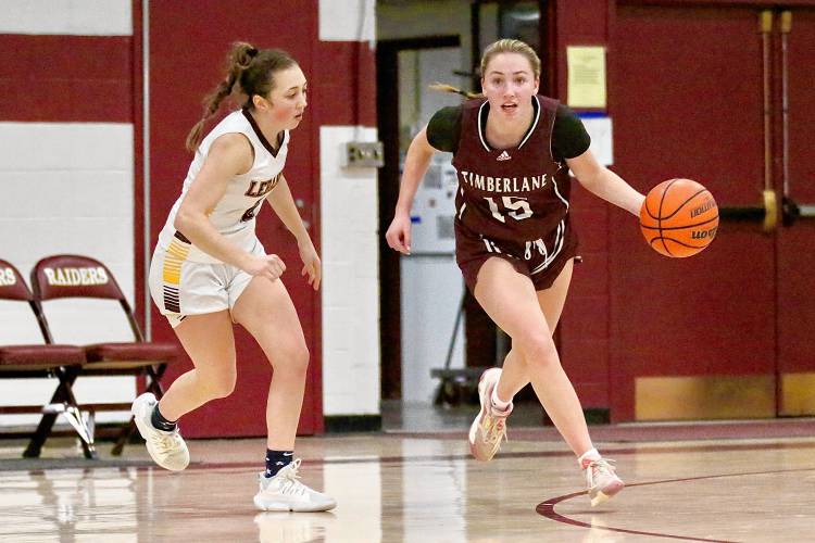 Timberlane High's Maia Parker (15) drives past Lebanon's Izzy Hamilton during the NHIAA Division II teams' Feb. 15, 2024, game in Lebanon, N.H. Timberlane won, 47-39, in overtime, with Parker scoring a game-high 23 points. (Valley News - Tris Wykes) Copyright Valley News. May not be reprinted or used online without permission.