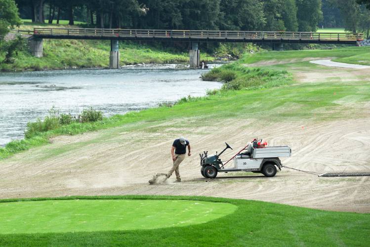 A worker stops to break up a clod of dirt while dragging a section of fairway on the Lakeland Golf Course at Quechee Lakes in Quechee, Vt., on Monday, August 21, 2023. Last week, the Quechee Lakes Landowners Association levied a $2,150 