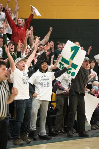 White River Valley fans, from left, Joey Ferris Kwai, Antwi, and Braden White, cheer on senior Tanner Drury after she sank a three pointer, bringing her within one point of her 1,000th career point during a Wildcats girls basketball game with Woodstock in South Royalton, Vt., on Monday, Jan. 22, 2024. Drury started the game needing six points to reach the mark. White River Valley won the game 56 - 24. (Valley News - James M. Patterson) Copyright Valley News. May not be reprinted or used online without permission. Send requests to permission@vnews.com.