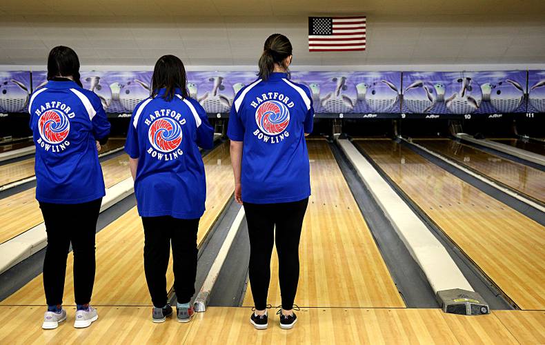 From left, Hartford bowlers Hailey Rogers, Nara Gallagher and Kara Robinson listen to 
