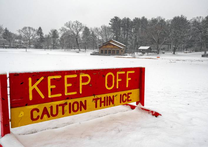 A sign to keep off the ice for the pond at White Park during the snowstorm on Thursday morning, January 12, 2023.