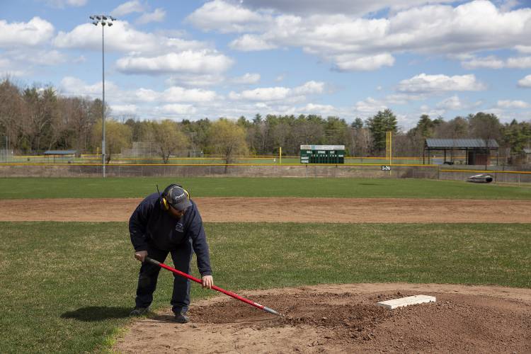 Corey Kenison, superintendent of parks and facilities with the Hartford Parks and Recreation Department, rakes the pitcher’s mound as he prepares the baseball diamond for Hartford High School’s Saturday home opener at Maxfield Outdoor Sports Complex in White River Junction, Vt., on Tuesday, April 16, 2024. “It’s nice to get back outside,” Kenison said. (Valley News / Report For America - Alex Driehaus) Copyright Valley News. May not be reprinted or used online without permission. Send requests to permission@vnews.com.