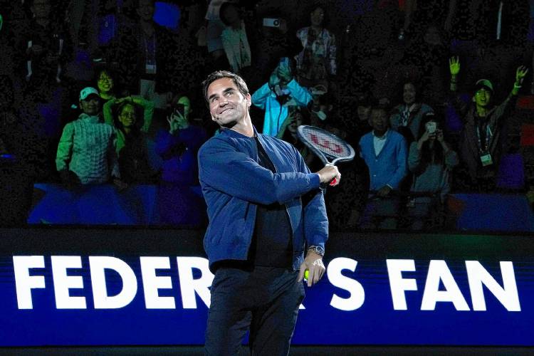 Retired tennis player Roger Federer hits an autographed ball to spectators during a Federer's fan day, a side event of the Shanghai Masters tennis tournament at Qizhong Forest Sports City Tennis Center in Shanghai, China, Friday, Oct. 13, 2023. (AP Photo/Andy Wong)