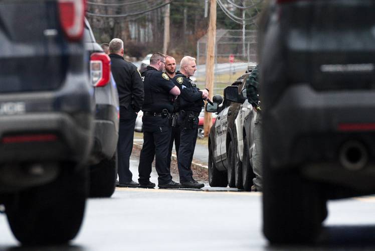 Lebanon Police Cpl. Jeremy Perkins, right, talks with the driver of a vehicle who was stopped on his way to the Hanover Street School in Lebanon, N.H., on Friday, March 15, 2024. Lebanon Police were alerted by Vermont State Police after a concerned caller said that the man was threatening himself and might pick up his child at the school. (Valley News - James M. Patterson) Copyright Valley News. May not be reprinted or used online without permission. Send requests to permission@vnews.com.
