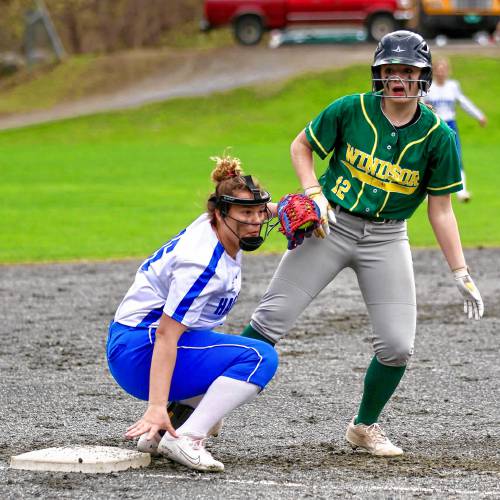 Hartford High's Serenitee Martel tags out Windsor's Brianna Barton during the team's April 18, 2023, game in Windsor, Vt. (Valley News - Tris Wykes) Copyright Valley News. May not be reprinted or used online without permission.