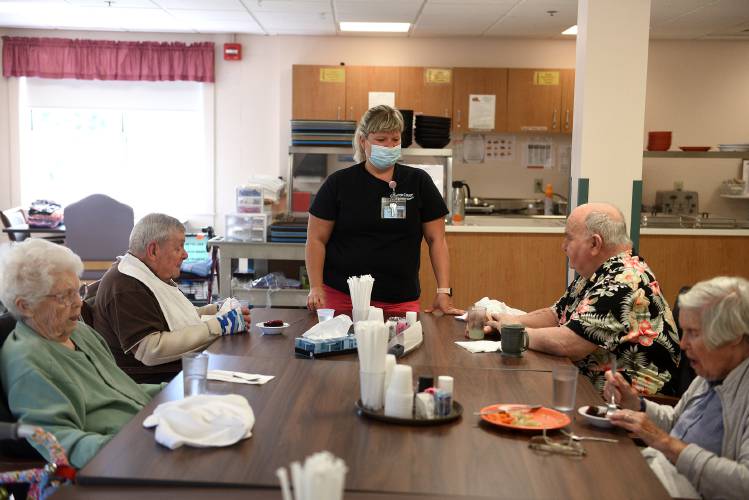 Residents Bea Wendell, 90, left, Paul Pinkham, 86, Dean Hurlbert, 80, and Betty Kane, 96, finish up their lunch at the Grafton County Nursing Home with licensed nursing assistant Raylynn Taylor checking in on them on Thursday, Sept. 14, 2023, in North Haverhill, N.H. (Valley News - Jennifer Hauck) Copyright Valley News. May not be reprinted or used online without permission. Send requests to permission@vnews.com.