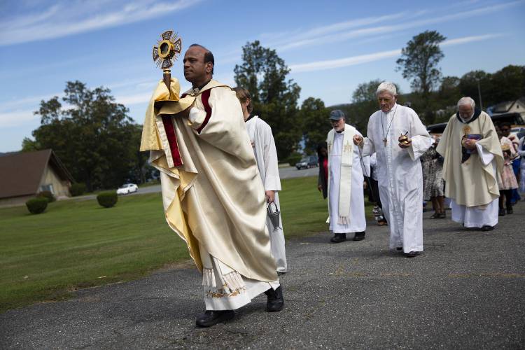 The Very Rev. William Kaliyadan carries the monstrance during a procession to the top of the hill for a retelling of the story of the apparition of Our Lady of La Salette during a celebration of her feast day at the Shrine of Our Lady of La Salette in Enfield, N.H., on Sunday, Sept. 17, 2023. Kaliyadan led Sacred Heart Parish in Lebanon, N.H., for 11 years before being reassigned in 2014, and now serves as the Provincial Superior for the North American Province based at the National La Salette Shrine in Attleboro, Mass. (Valley News / Report For America - Alex Driehaus) Copyright Valley News. May not be reprinted or used online without permission. Send requests to permission@vnews.com.