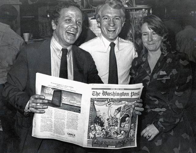 John Kuhns, center, stands with editor Noel Epstein, left, and associated editor Lois Reed Munday, as the first edition of the Washington Post National Weekly Edition, which Kuhns was in charge of launching, rolls off the Washington Post's press in November 1983. The first edition was dated Nov. 7, 1983. The last edition was published on Dec. 21, 2009. (Courtesy photograph)