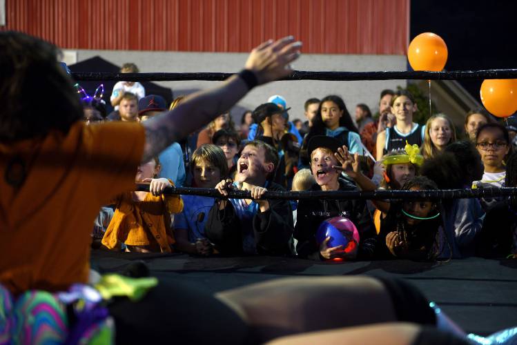 Young spectators watch a professional wrestling match between Kennedi Copeland and Isana at the Autumn Moon Festival on Friday, Oct. 6, 2023, in Windsor, Vt. Wrestlers from Impulse Wrestling drew boisterous crowds during the festival. (Valley News - Jennifer Hauck) Copyright Valley News. May not be reprinted or used online without permission. Send requests to permission@vnews.com.