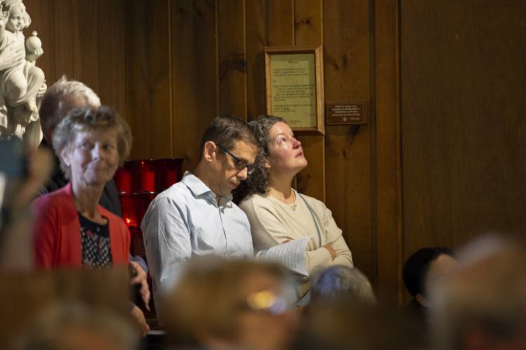 Amy Mancini, right, of Hanover, N.H., holds back tears as she stands with her husband Joshua during the closing Mass of the Shrine of Our Lady of La Salette in Enfield, N.H., on Tuesday, Sept. 19, 2023. Mancini moved to the shrine with her family when she was five years old and grew up surrounded by a community of lay and religious adults who all pitched in to help raise her and her brother. (Valley News / Report For America - Alex Driehaus) Copyright Valley News. May not be reprinted or used online without permission. Send requests to permission@vnews.com.