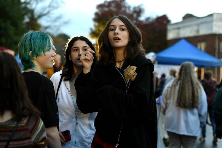 Rylie Cahoon, 16, of Windsor, Vt., holds her bearded dragon Walter while walking with friends Emma Simino, 16, of Perkinsville, Vt., and Roxie Sherwin, 15, of Windsor, while at the Autumn Moon Festival on Friday, Oct. 6, 2023, in Windsor.  (Valley News - Jennifer Hauck) Copyright Valley News. May not be reprinted or used online without permission. Send requests to permission@vnews.com.