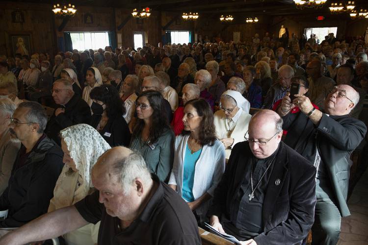 Brother Ron Taylor, right, of the National Shrine of Our Lady of La Salette in Attleboro, Mass., uses his cellphone to take a photo during the closing Mass of the Shrine of Our Lady of La Salette in Enfield, N.H., on Tuesday, Sept. 19, 2023. The chapel was filled to capacity for the shrine’s final Mass, with many attendees traveling from around New England to be there for the closing service. (Valley News / Report For America - Alex Driehaus) Copyright Valley News. May not be reprinted or used online without permission. Send requests to permission@vnews.com.